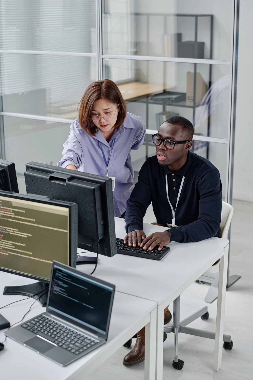 DevOps engineers monitoring cloud infrastructure, CI/CD pipelines, and enterprise system performance in a modern operations center