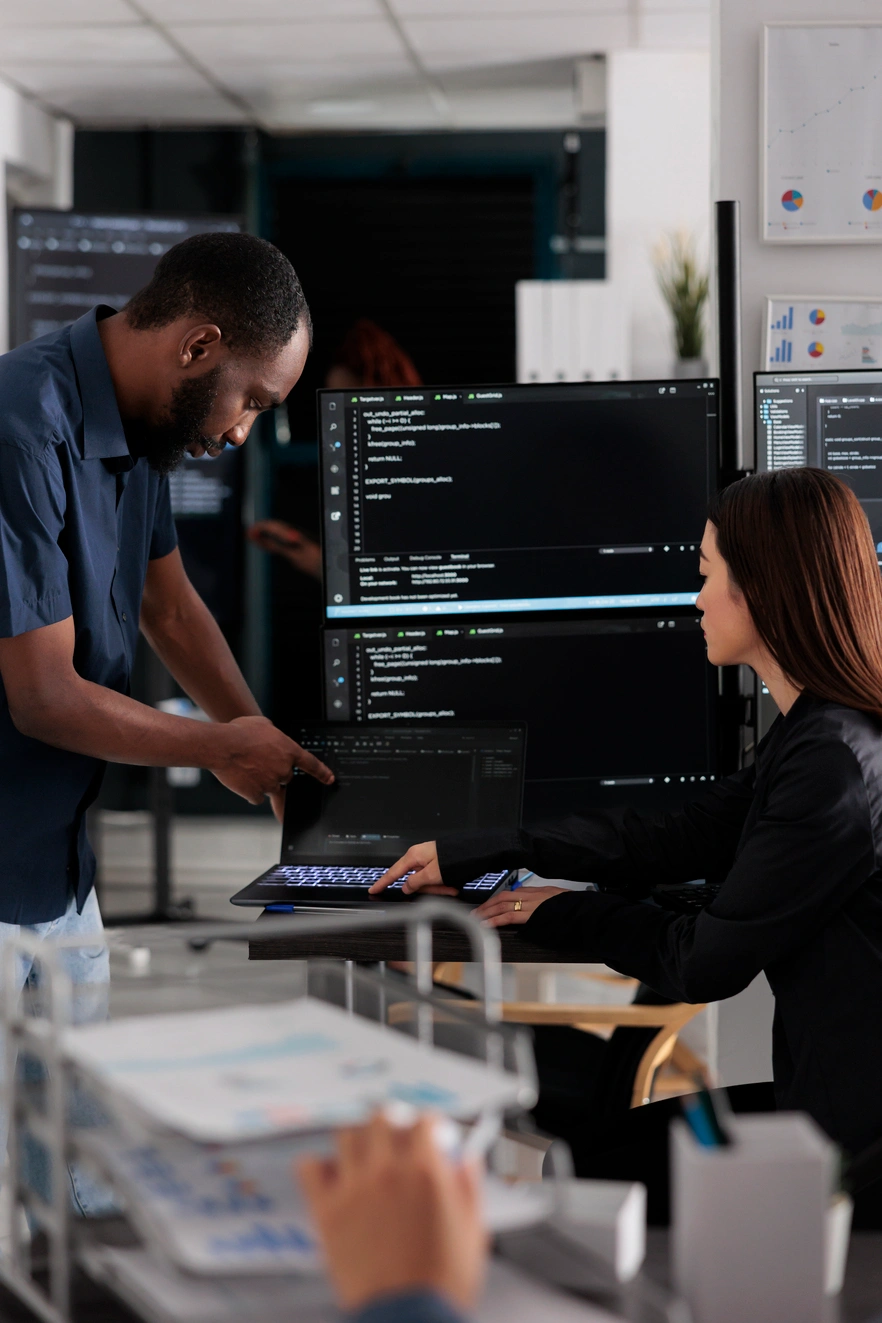 DevOps engineers monitoring cloud infrastructure, CI/CD pipelines, and enterprise system performance in a modern operations center