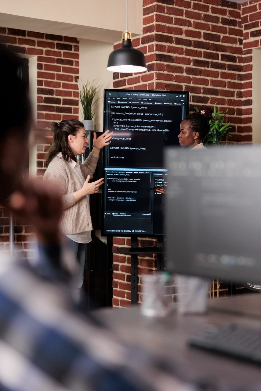 DevOps engineers monitoring cloud infrastructure, CI/CD pipelines, and enterprise system performance in a modern operations center