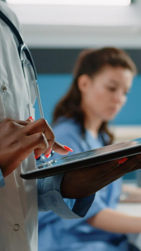 Customer service representative reviewing healthcare benefits information on a computer while assisting a member through a digital support platform.