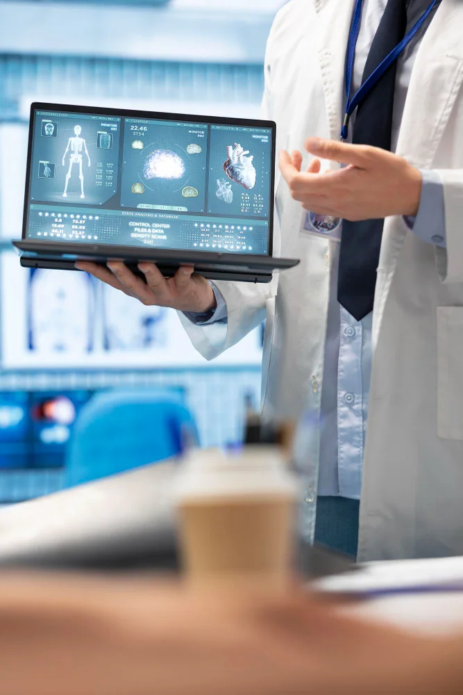 Customer service representative reviewing healthcare benefits information on a computer while assisting a member through a digital support platform.