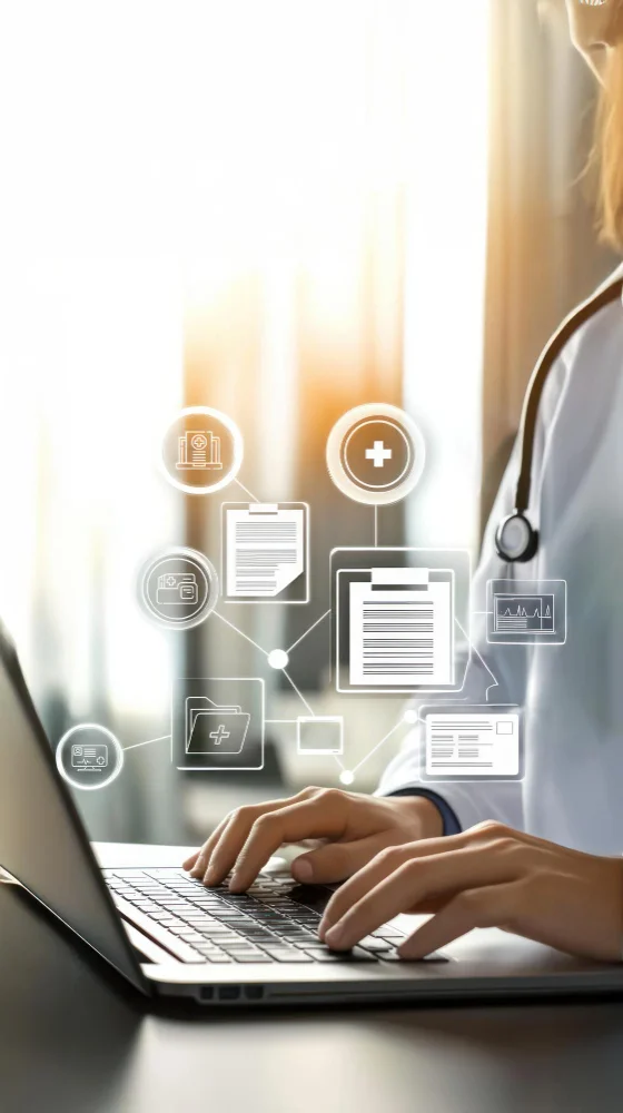 Customer service representative reviewing healthcare benefits information on a computer while assisting a member through a digital support platform.